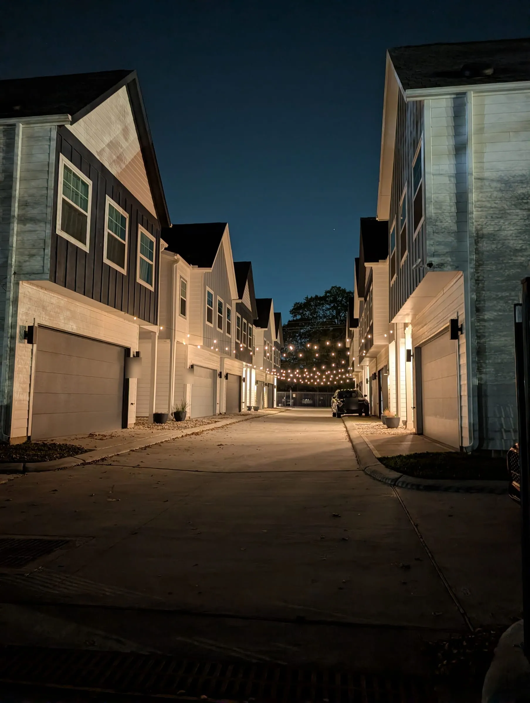 Northfield Villas lane at night under string lights
